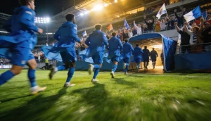 Fodboldhold der gar i omklædningsrummet i pausen med stadionlys og groent graes i baggrunden